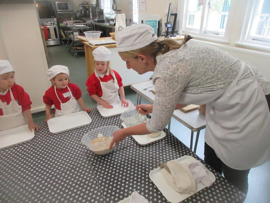 students rolling out dough