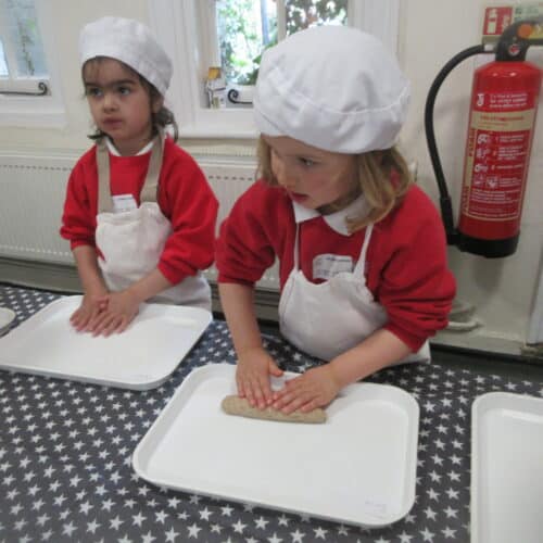 students rolling out dough