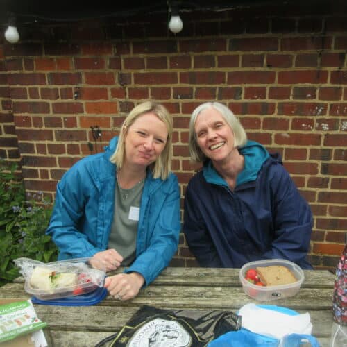 teachers eating lunch on a picnic bench