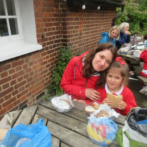 student and teacher eating lunch on a picnic bench