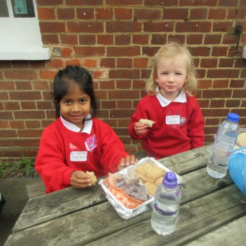 students eating lunch on a picnic bench