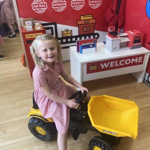 student riding a small tractor